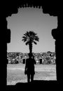 Black and white consept with silhouette woman and her over the palm tree branches. Art working photograph Royalty Free Stock Photo