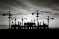 Black and white construction site with several cranes silhouette concept Royalty Free Stock Photo