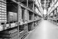 A black and white defocused image of a store warehouse, or factory warehouse. Industrial theme