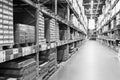 A black and white defocused image of a store warehouse, or factory warehouse. Industrial theme