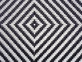 A black and white diamond pattern formed in woven plastic as a background Royalty Free Stock Photo