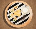 Black and white dish with handmade ravioli in the shape of heart,open and closed,fresh cheese and few grains of black pepper. Royalty Free Stock Photo