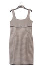 Black and white dress with checkered pattern is on coat-hanger, pinafore dress