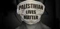 Black and white effect of woman wearing a mask with Palestinian lives matter. Save palestine and al aqsa  Jerusalem  concept. Royalty Free Stock Photo