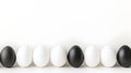 Black and white eggs arranged in a row on a white background. Perfect for minimalist designs, Easter concepts, or Royalty Free Stock Photo