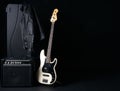 Black and white electric bass guitar with amplifier, jack cable Royalty Free Stock Photo