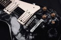 Black and white electric bass guitar. Musical instrument close-up. Royalty Free Stock Photo