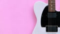 Black and white electric guitar on a pink background. Royalty Free Stock Photo