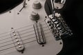 Black and white electronic guitar close up view. Royalty Free Stock Photo