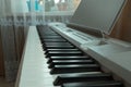 electronic piano with white and black keys on the background of the window Royalty Free Stock Photo