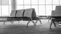 Black and white empty airport terminal waiting area with chairs Royalty Free Stock Photo