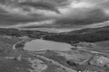 Black and white Epic aerial flying drone landscape image of Snowdon Massif viewed from above Llynau Mymber during Autumn sunset Royalty Free Stock Photo