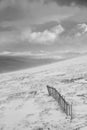 Black and white epic Winter landscape image from mountain top looking across to Rannoch Moor Royalty Free Stock Photo