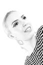 Black and white expressive portrait of a young stylish woman wearing stripes in the studio