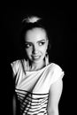 Black and white expressive portrait of a young stylish woman wearing stripes in the studio