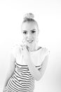 Black and white expressive portrait of a young stylish woman wearing stripes in the studio