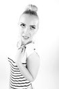 Black and white expressive portrait of a young stylish woman wearing stripes in the studio