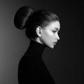 Black and white fashion art studio portrait of beautiful elegant woman in black turtleneck. Hair high beam, perfect profile face. Royalty Free Stock Photo