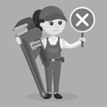 Black and white female plumber holding a false sign and giant pipe wrench Royalty Free Stock Photo