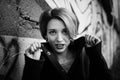 Black and white female portrait of young girl with short blonde hair near the wall with graffiti. Youth culture, street Royalty Free Stock Photo