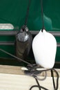 Black and white fenders suspended between a boat and dockside for protection. Maritime fenders Royalty Free Stock Photo