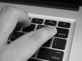 Black and white finger pushing delete button on a keyboard of computer Royalty Free Stock Photo