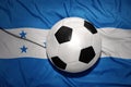 Black and white football ball on the national flag of honduras