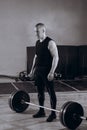 Black and white full length portrait of Strong man lifting a barbell at gym Royalty Free Stock Photo