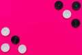 Black and white game checkers on a pink background. Board game, leisure. Flat lay, copy space Royalty Free Stock Photo