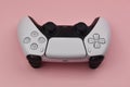 black and white game controllers on pink background Royalty Free Stock Photo