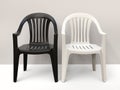 Black and white generic plastic chairs side by side Royalty Free Stock Photo