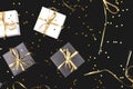 Black and white gift boxes with gold ribbon on shine background.