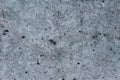 Top view of black, white, gray grunge textured rough stone background with cracks, scratches and stains.