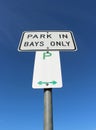 Black, white and green park in bays only sign Royalty Free Stock Photo