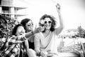 Black and white group of females friends have fun together in outdoor leisure activity after lockdown phase one coronavirus -