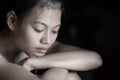 Black and white grunge image of a beautiful teenage girl sitting on the floor crying, Family problems, dysfunction, Royalty Free Stock Photo