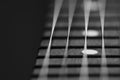 Black and white guitar fretoard bwith strings on black background Royalty Free Stock Photo