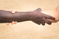 Black and white hands in modern handshake against racism