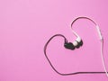 Black and white Headphones with heart shaped kissing on pink background Royalty Free Stock Photo