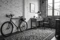 Black and white hipster room with bicycle, desk, pattern carpet Royalty Free Stock Photo