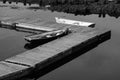 Black and white Horizontal image of a rowboat and a dory docked Royalty Free Stock Photo