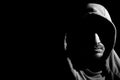 Black and white horizontal portrait shot of mysterious young bearded hooded man Royalty Free Stock Photo