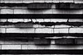 Black and white horizontal striped wall design from concrete rough long blocks. Abstract industrial cement grunge