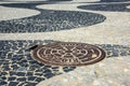 Black and white iconic mosaic by old design pattern with a manhole