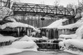 Black white icy waterfall under bridge Royalty Free Stock Photo