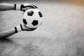 Black and white image of ball in hands of futsal goalkeeper on wooden futsal floor Royalty Free Stock Photo