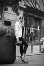 Black-white image of beautiful young girl. Beautiful young blond girl posing on street. Fashion, beauty Royalty Free Stock Photo