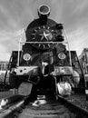 Black and white image of big black old steam train on the railroad Royalty Free Stock Photo