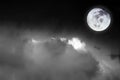 Black and white image of blurry cosmic clouds and bright full moon with stars on dark sky background. Royalty Free Stock Photo