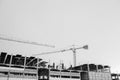 Black and white image of building crane and buildings under construction Royalty Free Stock Photo